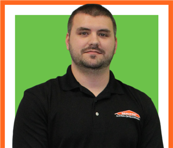 male servpro employee against green background