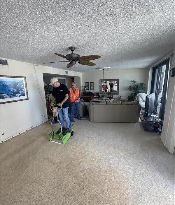 SERVPRO employee extracting water from carpet.
